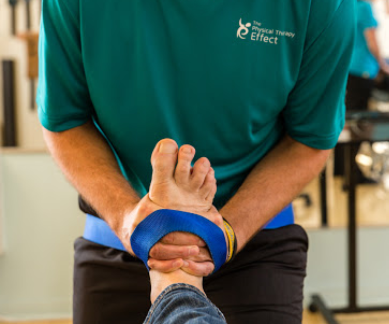 Doctor of physical therapy working on patient's foot
