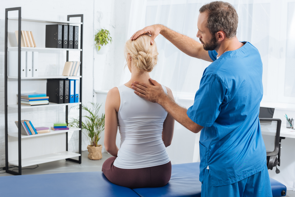 Physical therapist working on a patient’s neck