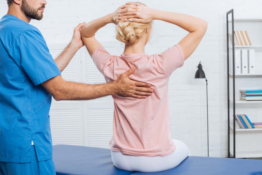 a physical therapist working with a patient who has back pain